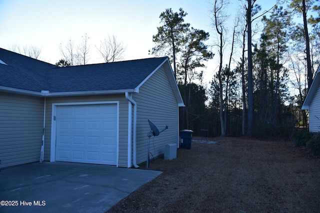 view of side of home featuring a garage