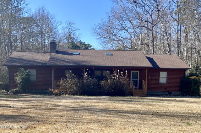 view of front of home with a garage, a front lawn, and a porch