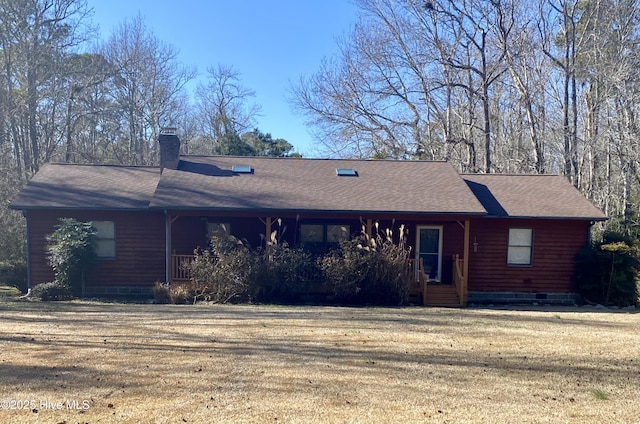 ranch-style house featuring a chimney, a porch, a shingled roof, a front yard, and crawl space