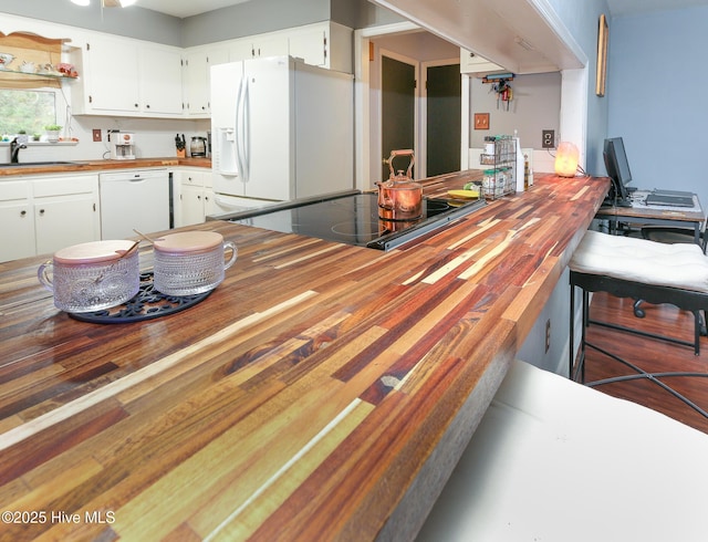 kitchen featuring white cabinetry, sink, white appliances, and wood counters