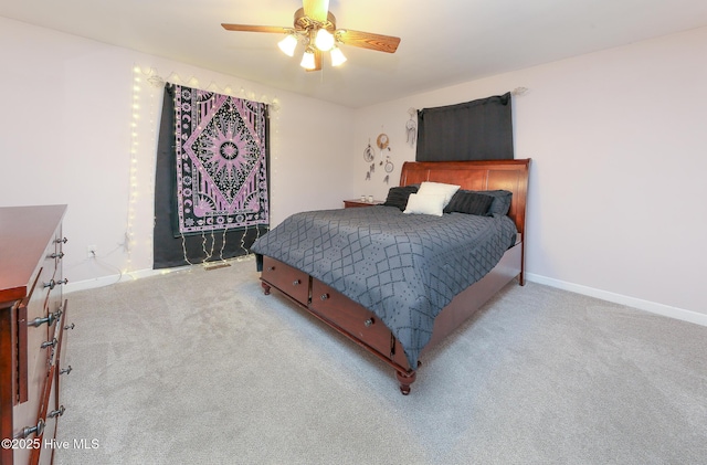 bedroom featuring baseboards, a ceiling fan, and light colored carpet