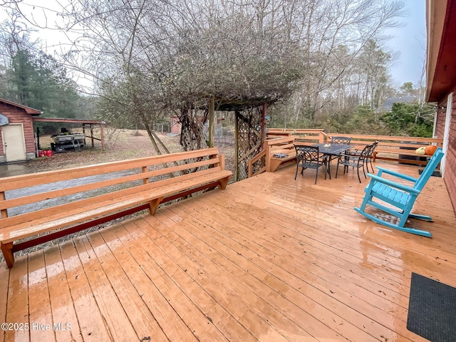 wooden terrace featuring outdoor dining space