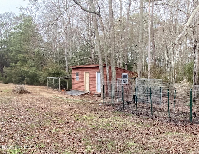 exterior space featuring an outbuilding and fence