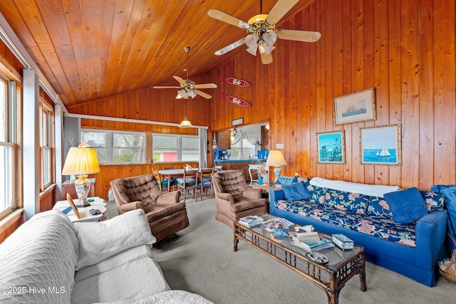 carpeted living room featuring wood ceiling, high vaulted ceiling, and wood walls