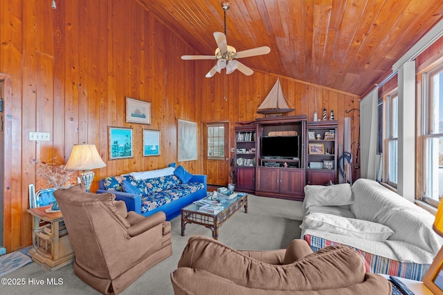 living room with wood walls, wood ceiling, vaulted ceiling, ceiling fan, and carpet