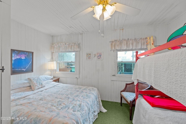 carpeted bedroom with multiple windows and ceiling fan