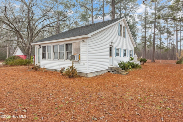 view of side of home featuring cooling unit