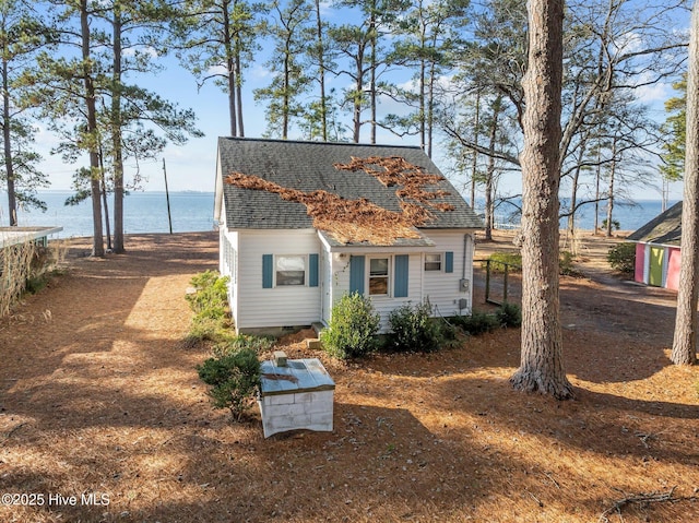 rear view of property with a water view