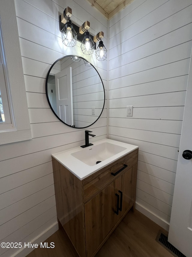 bathroom featuring vanity and hardwood / wood-style floors