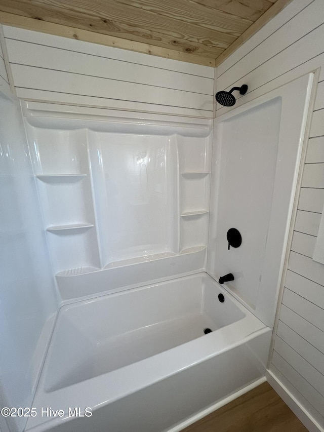 bathroom featuring wood ceiling, shower / tub combination, wood-type flooring, and wood walls