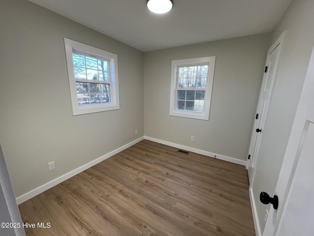 interior space with a healthy amount of sunlight and hardwood / wood-style floors