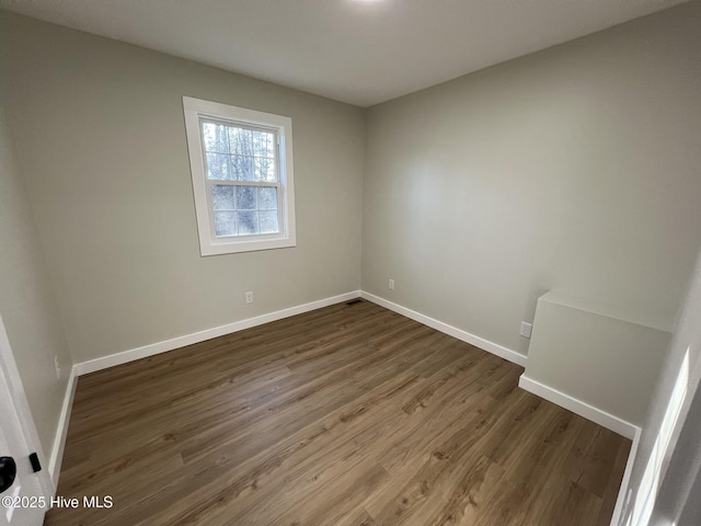 spare room featuring dark hardwood / wood-style flooring