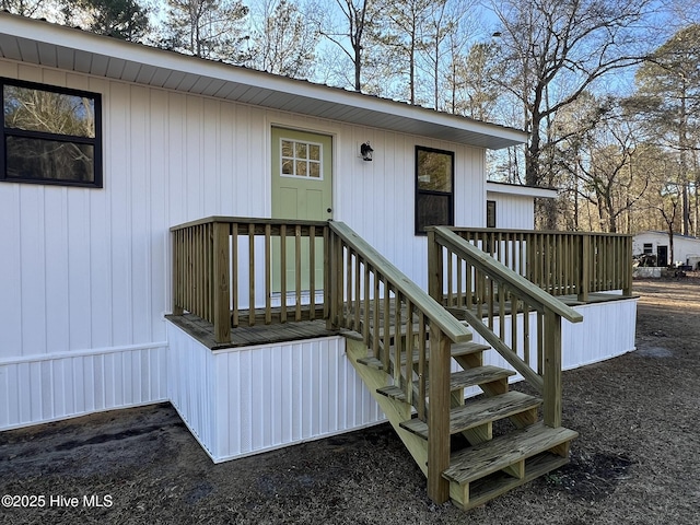 property entrance featuring a wooden deck