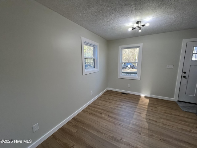 entryway featuring hardwood / wood-style floors and a textured ceiling