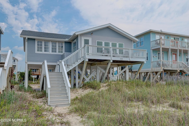 back of house featuring a wooden deck