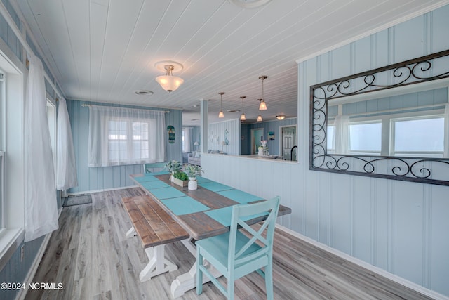 dining area featuring wood ceiling and light hardwood / wood-style flooring