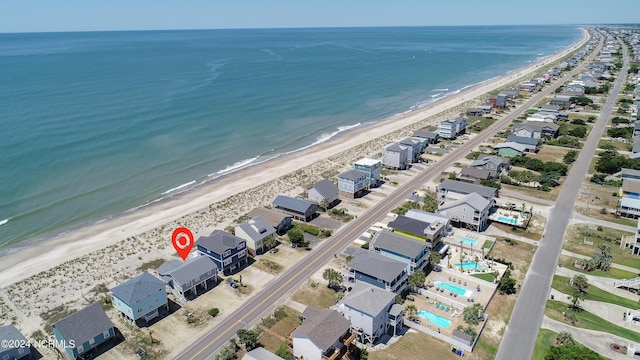 bird's eye view featuring a view of the beach and a water view