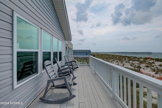 wooden terrace featuring a water view