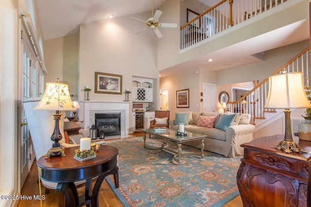 living room with hardwood / wood-style floors and ceiling fan