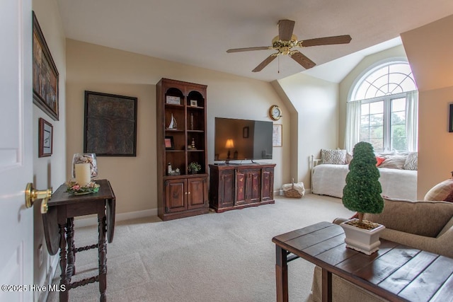 carpeted living room with lofted ceiling and ceiling fan