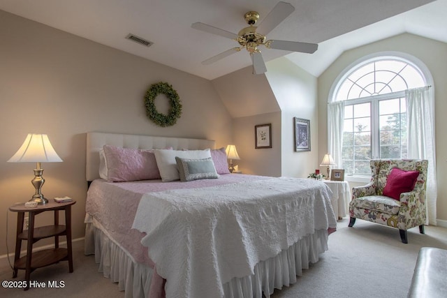 carpeted bedroom with ceiling fan and vaulted ceiling