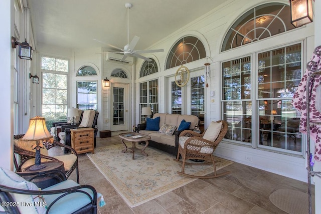 sunroom / solarium featuring a wall mounted air conditioner and ceiling fan