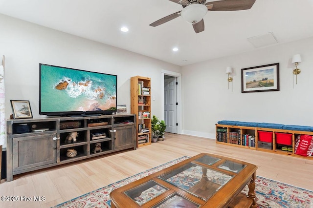 living room featuring hardwood / wood-style flooring and ceiling fan