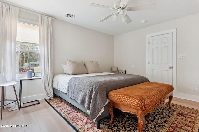 bedroom with ceiling fan and light wood-type flooring