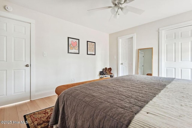 bedroom with ceiling fan and light hardwood / wood-style floors