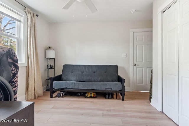 living area with ceiling fan and light wood-type flooring