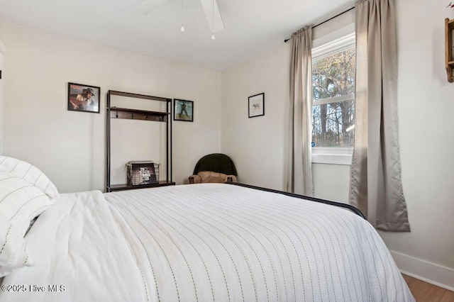 bedroom with ceiling fan and wood-type flooring