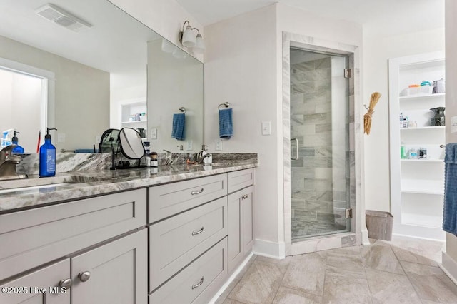 bathroom featuring vanity and an enclosed shower