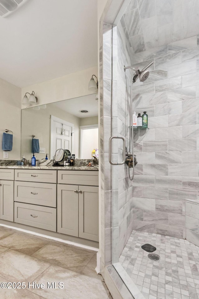 bathroom featuring walk in shower and vanity