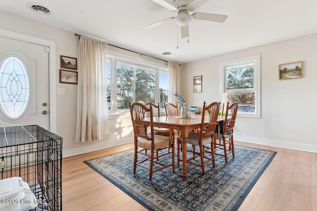 dining space with hardwood / wood-style floors and ceiling fan