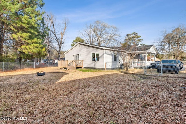 rear view of house featuring a deck