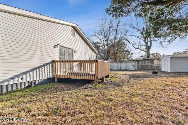 view of yard with a shed and a deck