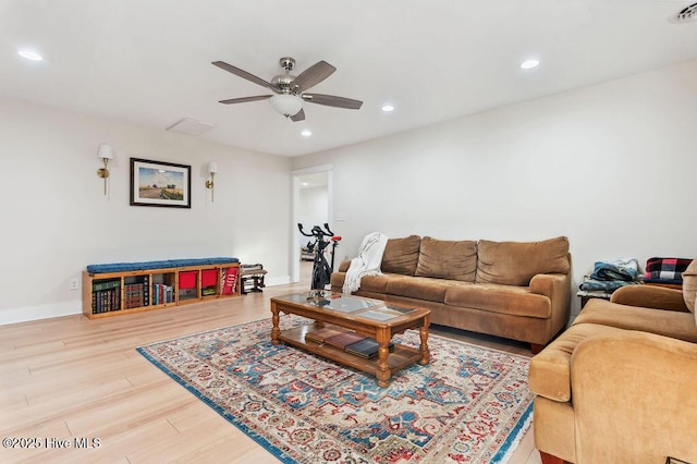 living room featuring hardwood / wood-style floors and ceiling fan