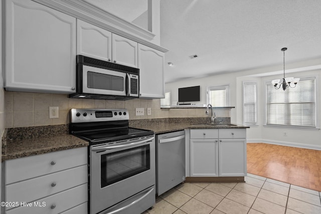 kitchen with sink, white cabinets, and appliances with stainless steel finishes