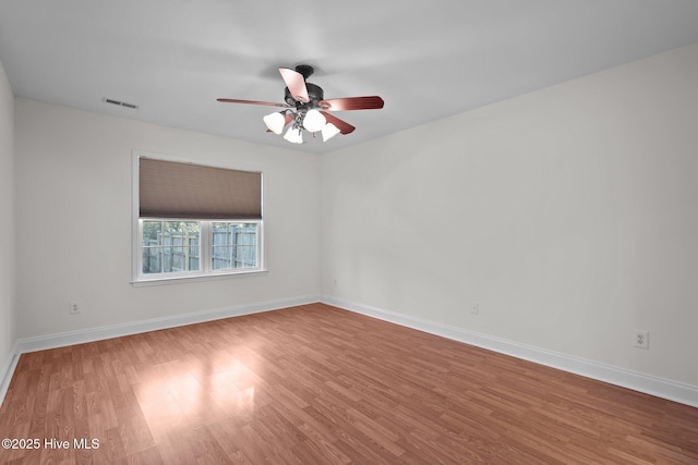 spare room featuring hardwood / wood-style flooring and ceiling fan