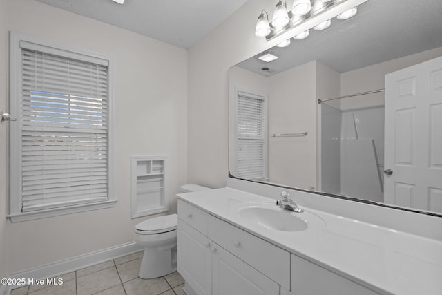 bathroom featuring vanity, a textured ceiling, tile patterned floors, toilet, and walk in shower