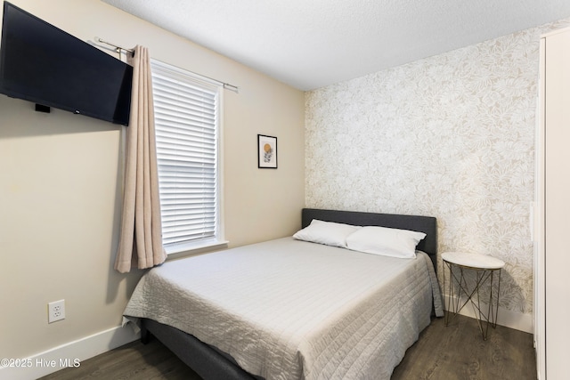 bedroom with dark wood-type flooring