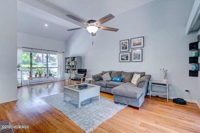 living room with ceiling fan, high vaulted ceiling, and light hardwood / wood-style floors