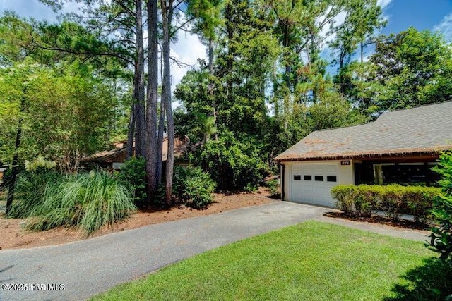 exterior space featuring a garage and a yard