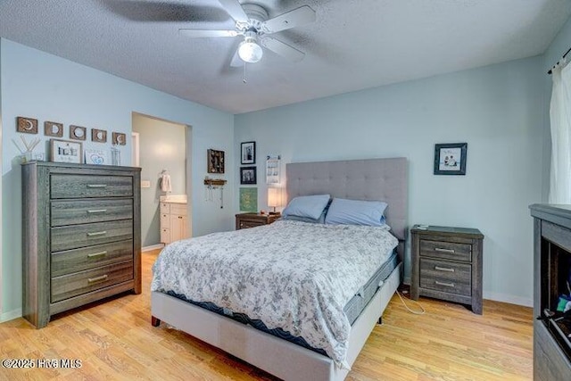 bedroom featuring ceiling fan, a textured ceiling, and light wood-type flooring