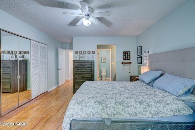 bedroom with hardwood / wood-style flooring, ceiling fan, ensuite bathroom, a textured ceiling, and a closet