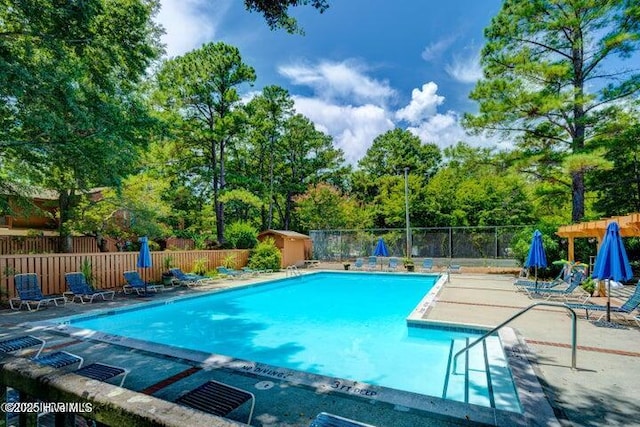 view of swimming pool featuring a shed