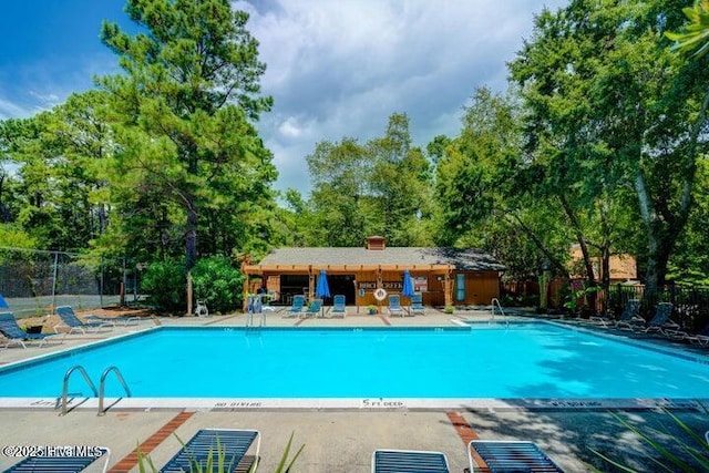 view of swimming pool featuring a patio area