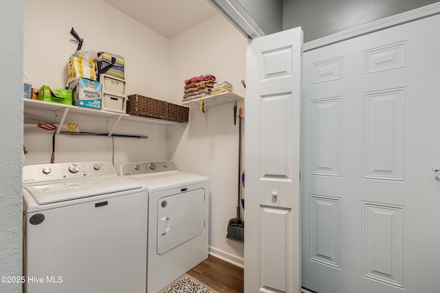 washroom with dark hardwood / wood-style floors and washing machine and dryer