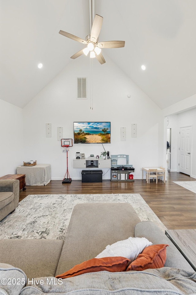 living room with ceiling fan, hardwood / wood-style floors, and high vaulted ceiling