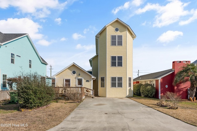 view of front facade with a deck and concrete driveway